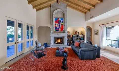 a living room with furniture fireplace and window