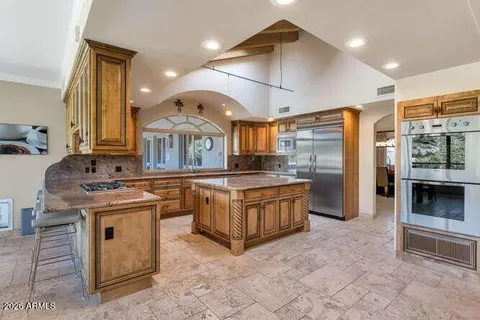 a kitchen with stainless steel appliances granite countertop a stove and a sink