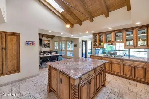 a kitchen with a stove sink and cabinets