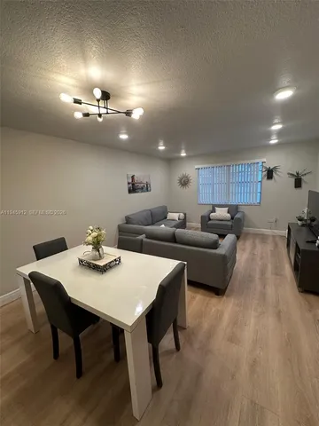 a large kitchen with a table and chairs