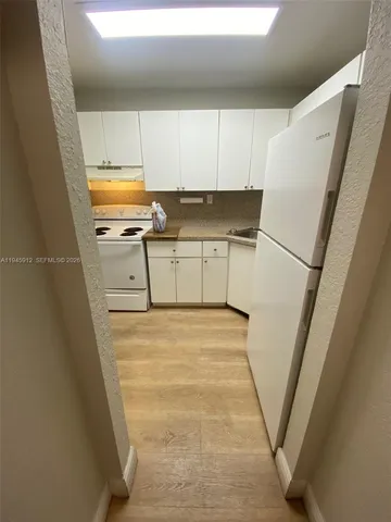 a room with wooden cabinets and a sink
