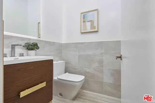 a living room with furniture a rug and a painting