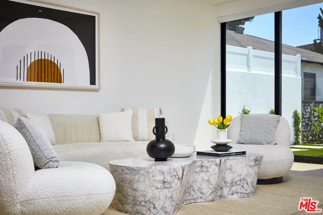 a living room with furniture and white walls