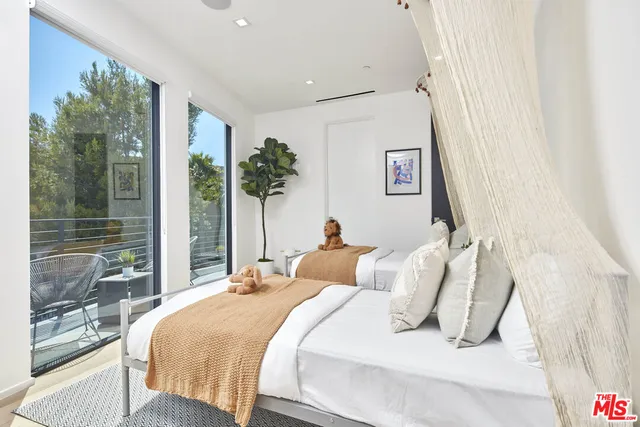 a bedroom with a large bed and a chandelier