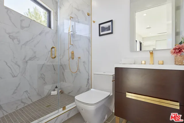 a bedroom with a bed and a potted plant