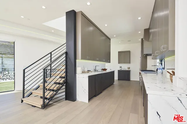 a view of kitchen and hall with wooden floor