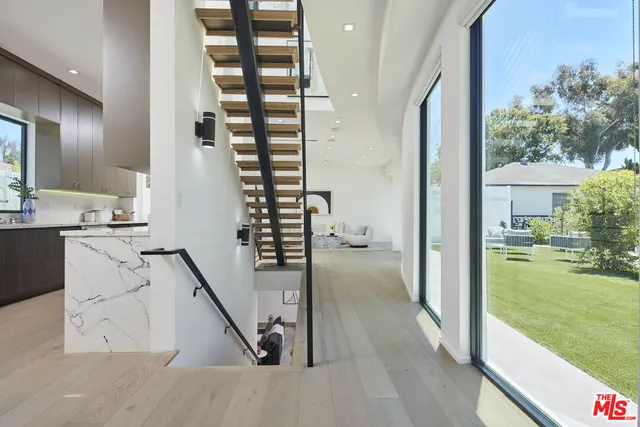 a view of a dining room that has a table and chairs in it