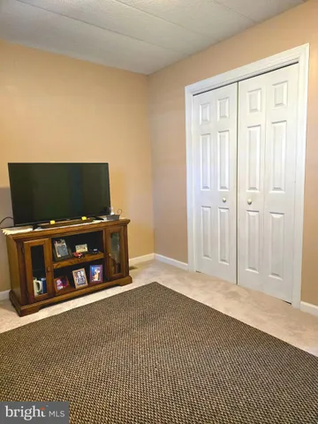 a living room with a flat screen tv and a fireplace