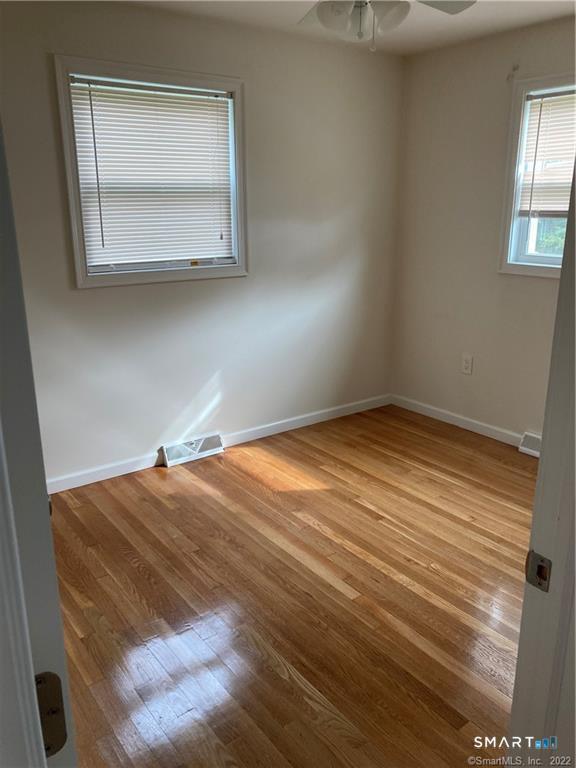 50 Short Beach Road Branford, CT 06405 - Photo 13 of 15 a room with a bed and mirror