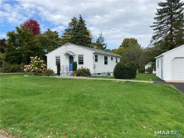 a front view of house with yard and green space