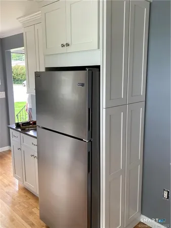 a white refrigerator freezer sitting inside of a kitchen