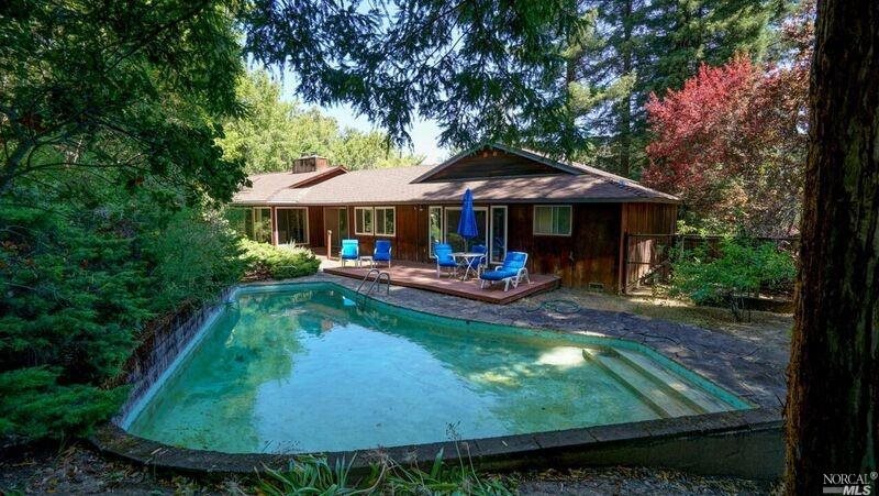 61 Legend Road San Anselmo, CA 94960 - Photo 1 of 1 a view of swimming pool with lawn chairs under an umbrella