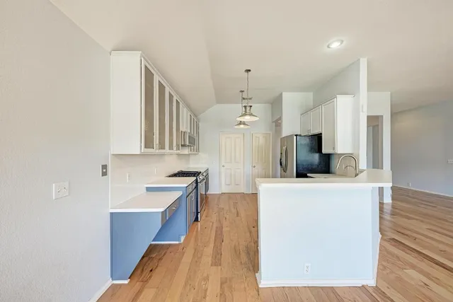 a kitchen with stainless steel appliances a refrigerator and a sink