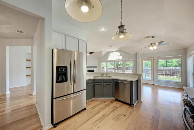 a kitchen that has a sink and a large window