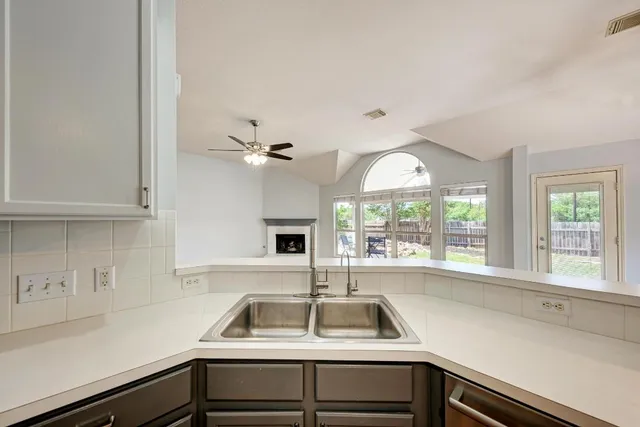 a kitchen with stainless steel appliances granite countertop a stove and a sink