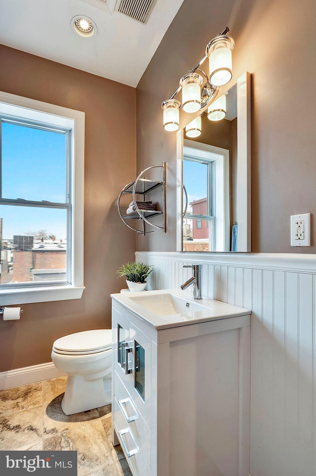 818 12th Street Northeast Washington, DC 20002 - Photo 14 of 29 a bathroom with a toilet sink and mirror