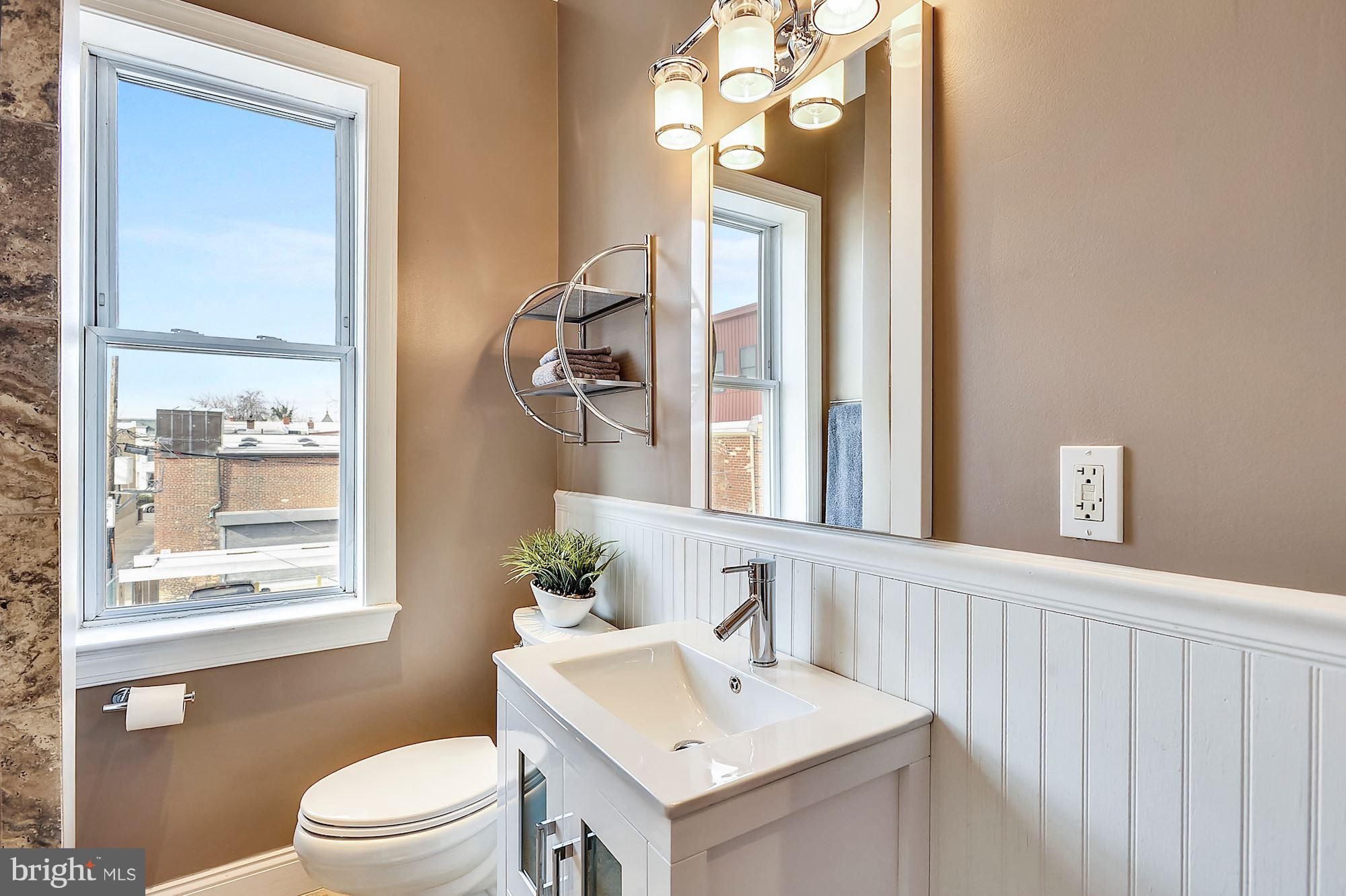 818 12th Street Northeast Washington, DC 20002 - Photo 15 of 29 a bathroom with a sink a toilet and a mirror