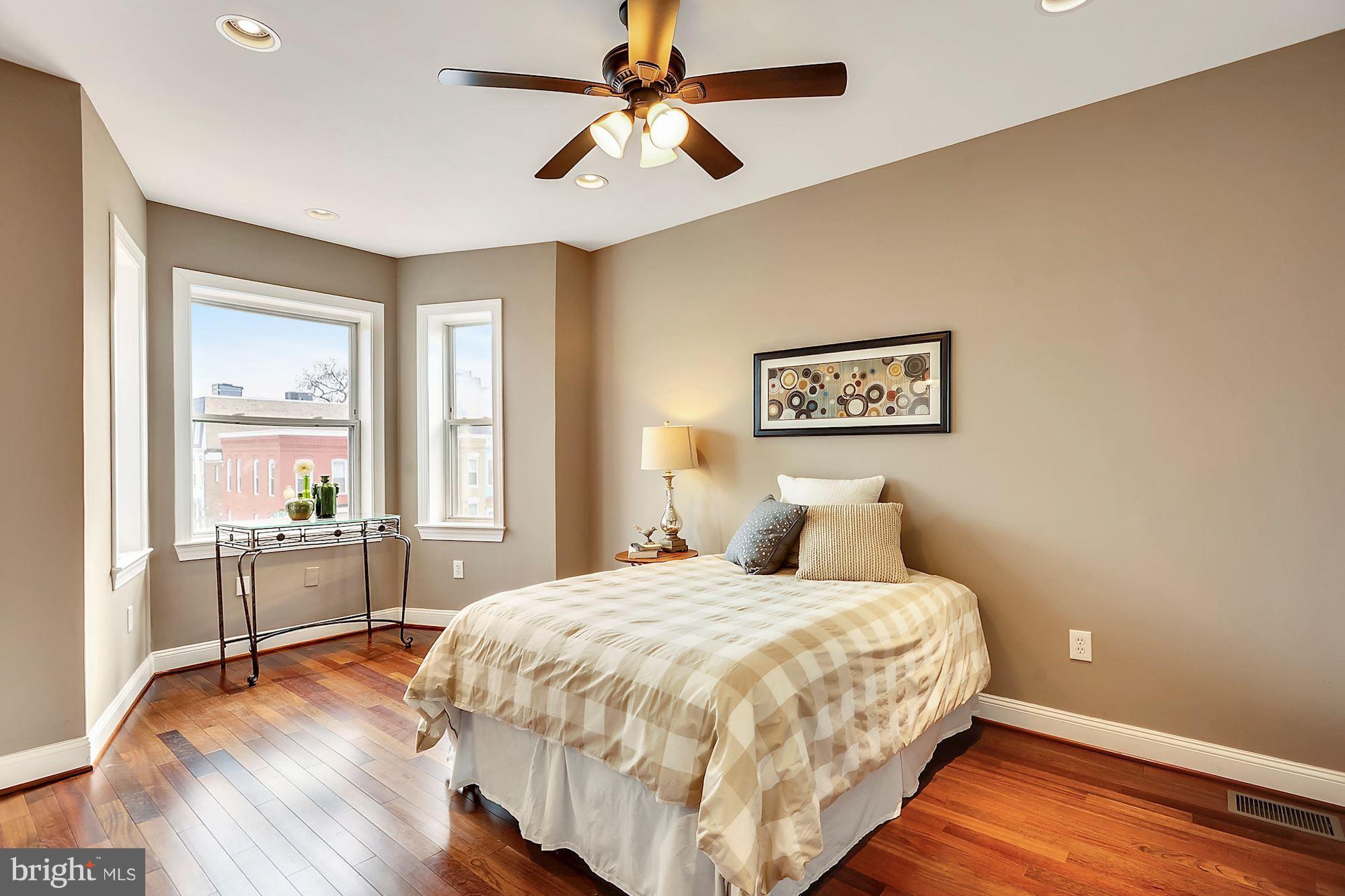 818 12th Street Northeast Washington, DC 20002 - Photo 17 of 29 a bedroom with a large bed and a chandelier