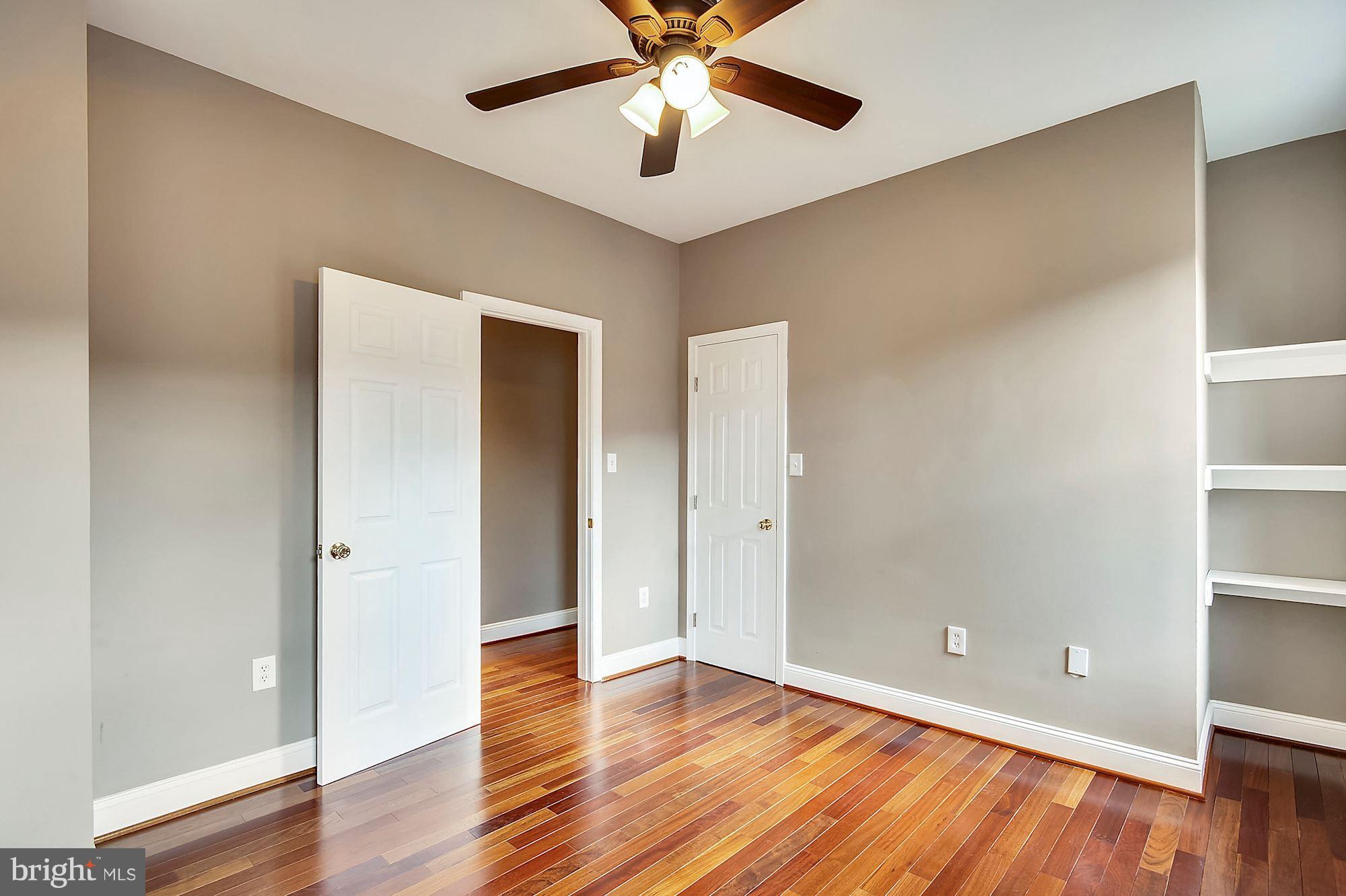 818 12th Street Northeast Washington, DC 20002 - Photo 21 of 29 an empty room with wooden floor and a ceiling fan