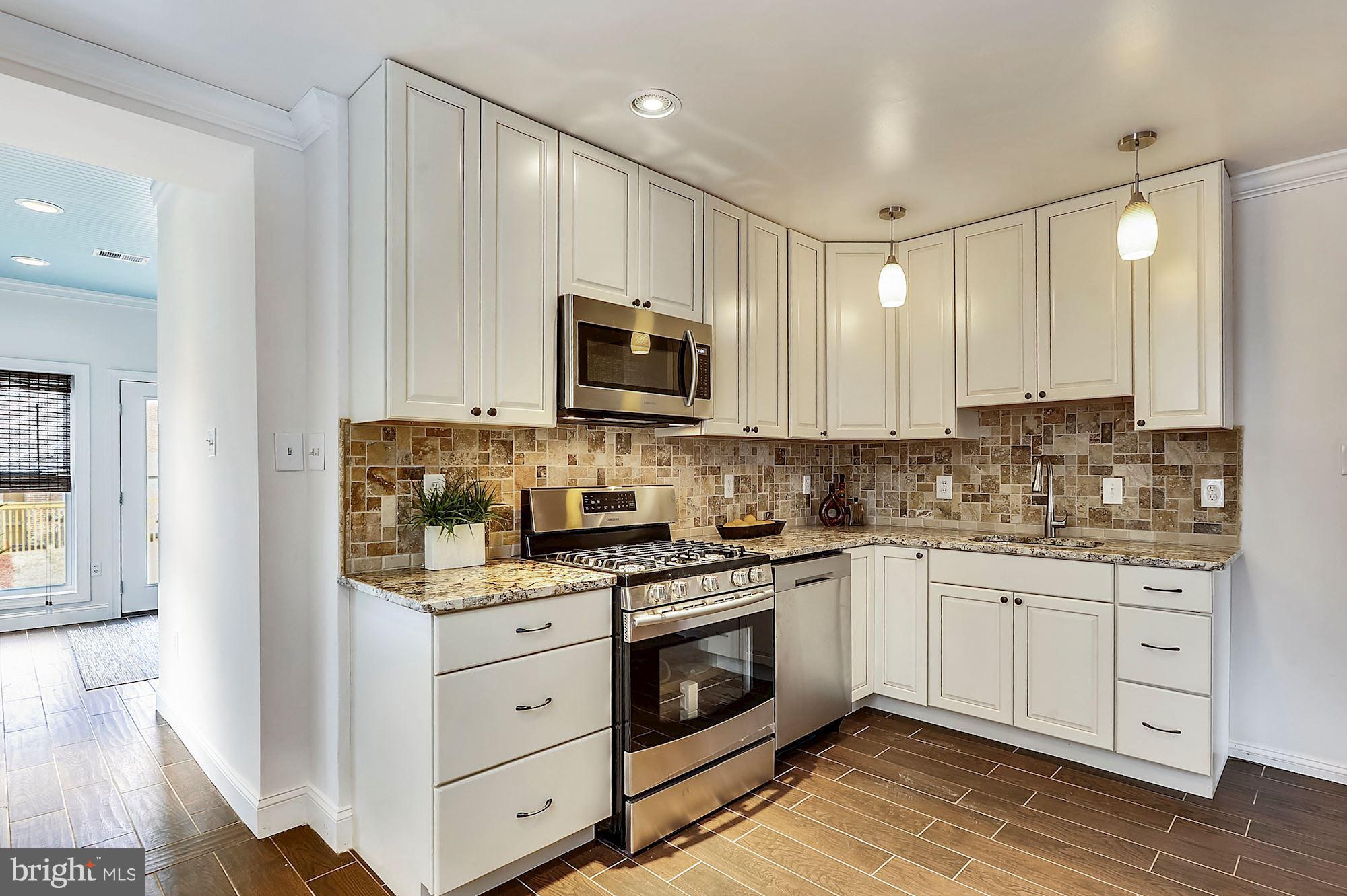 818 12th Street Northeast Washington, DC 20002 - Photo 9 of 29 a kitchen with appliances a sink and cabinets