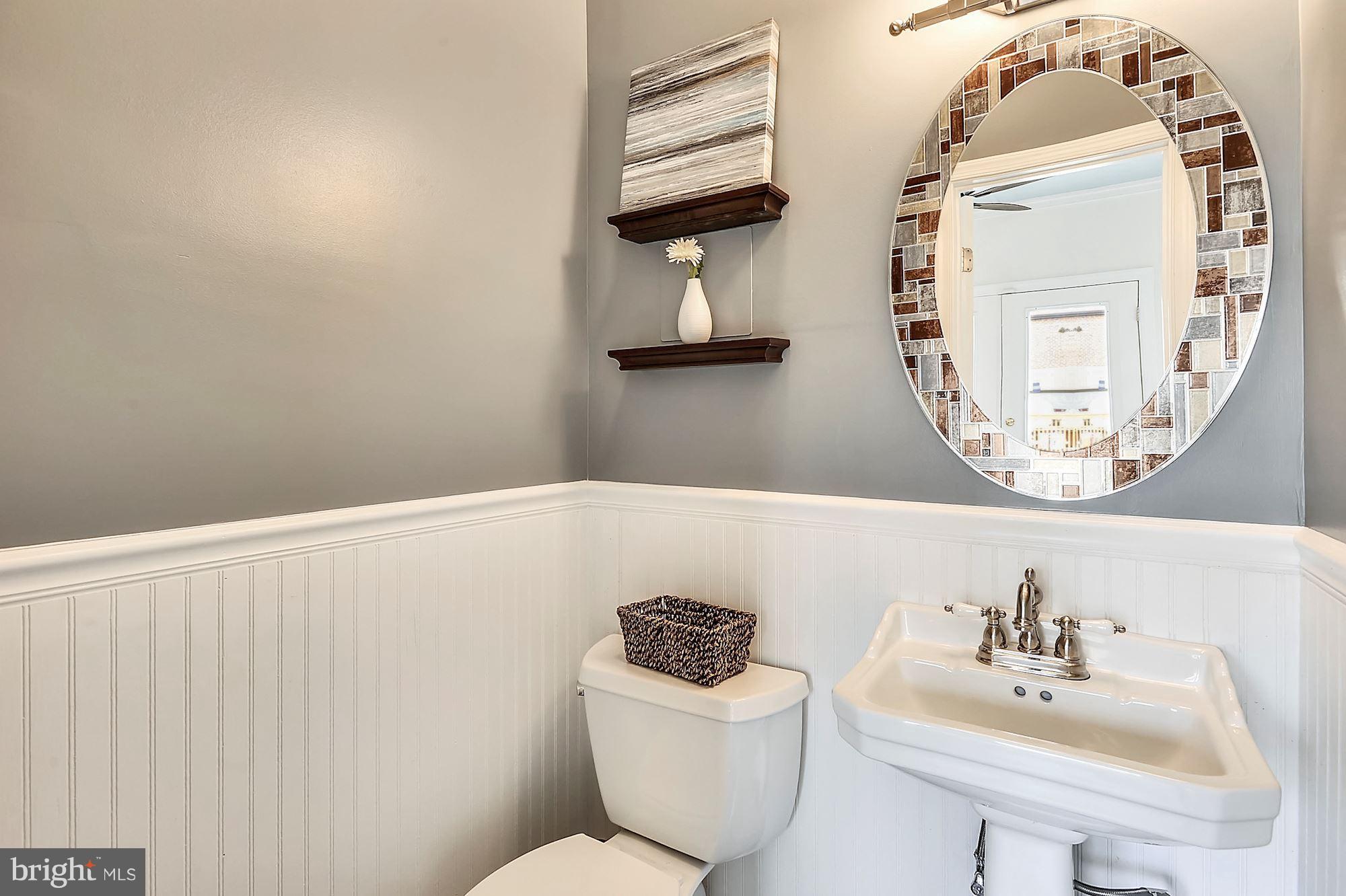 818 12th Street Northeast Washington, DC 20002 - Photo 10 of 29 a bathroom with a sink mirror and toilet