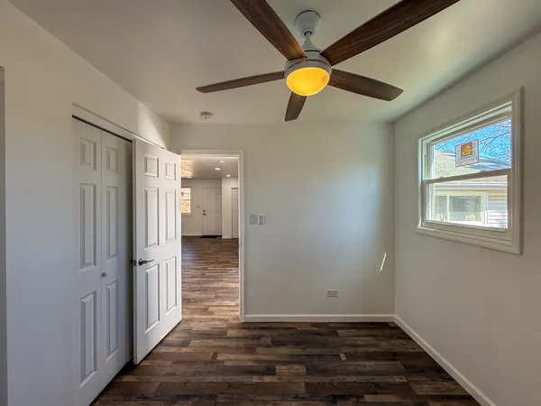 a view of an empty room with wooden floor