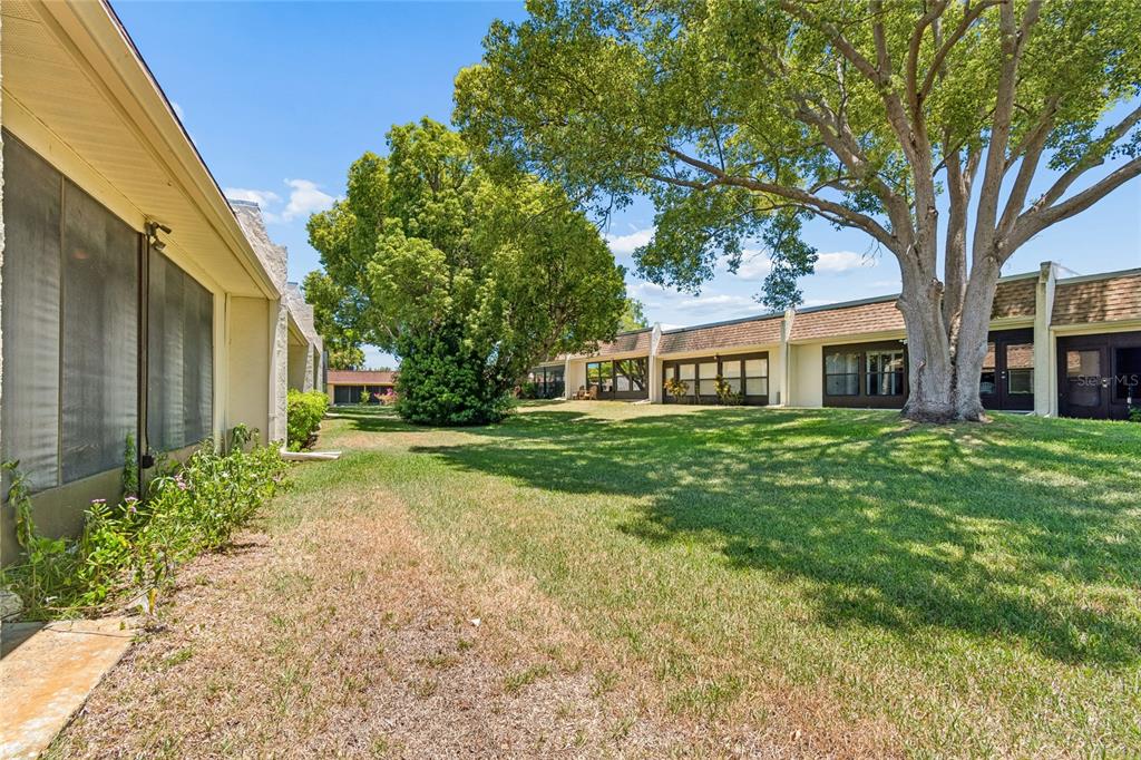 11340 Carriage Hill Drive, Unit 4 Port Richey, FL 34668 - Photo 21 of 36 a front view of a house with garden