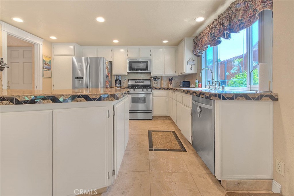 24 Edgebrook Drive Phillips Ranch, CA 91766 - Photo 16 of 75 a kitchen with stainless steel appliances granite countertop a stove a sink and a refrigerator