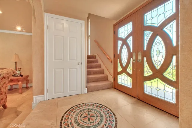 a view of an entryway with wooden floor and a front door