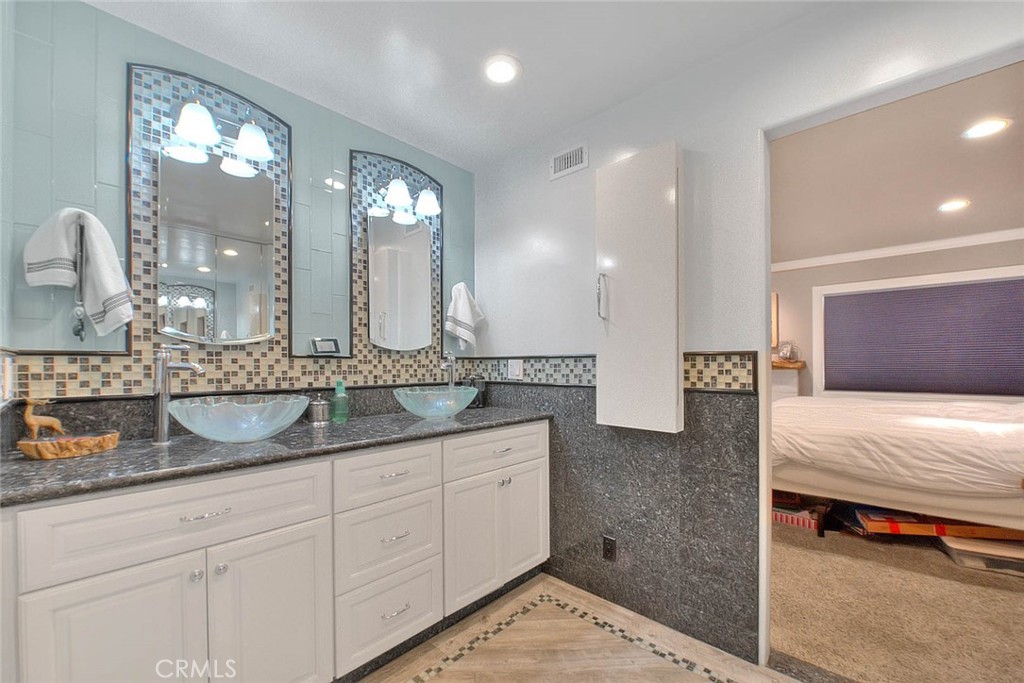 24 Edgebrook Drive Phillips Ranch, CA 91766 - Photo 44 of 75 a bathroom with double vanity and a mirror