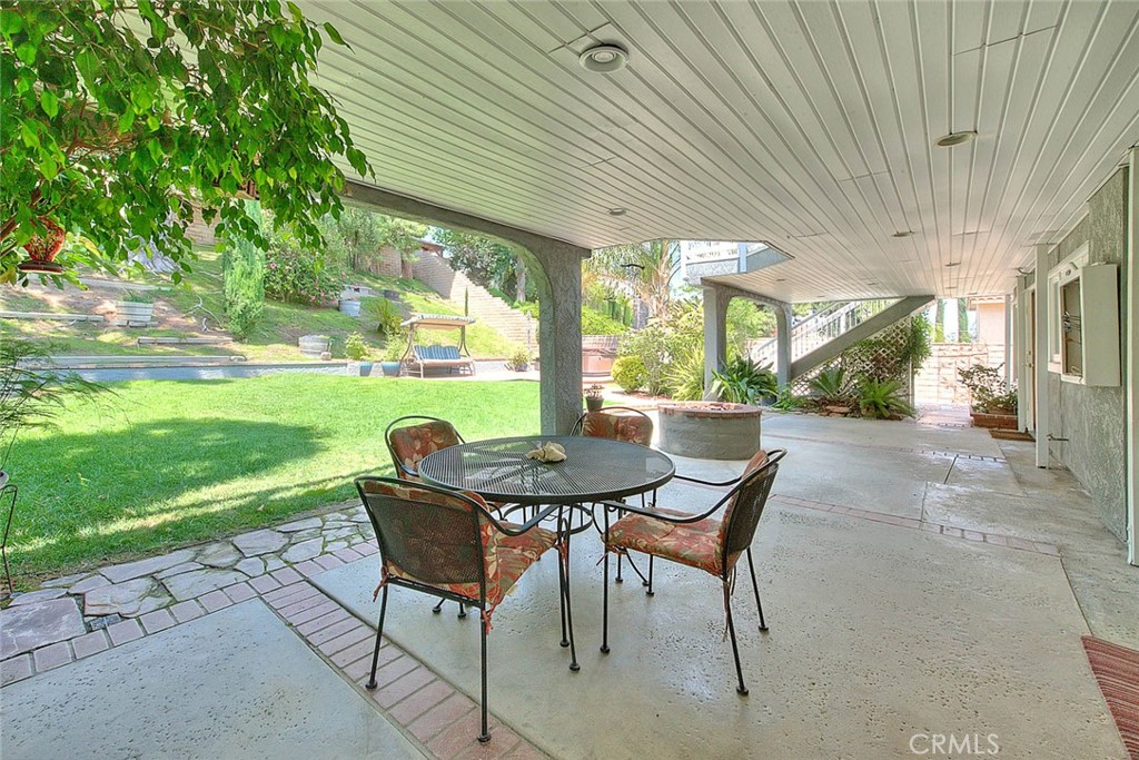24 Edgebrook Drive Phillips Ranch, CA 91766 - Photo 53 of 75 a patio with table and chairs and couches with wooden fence and plants