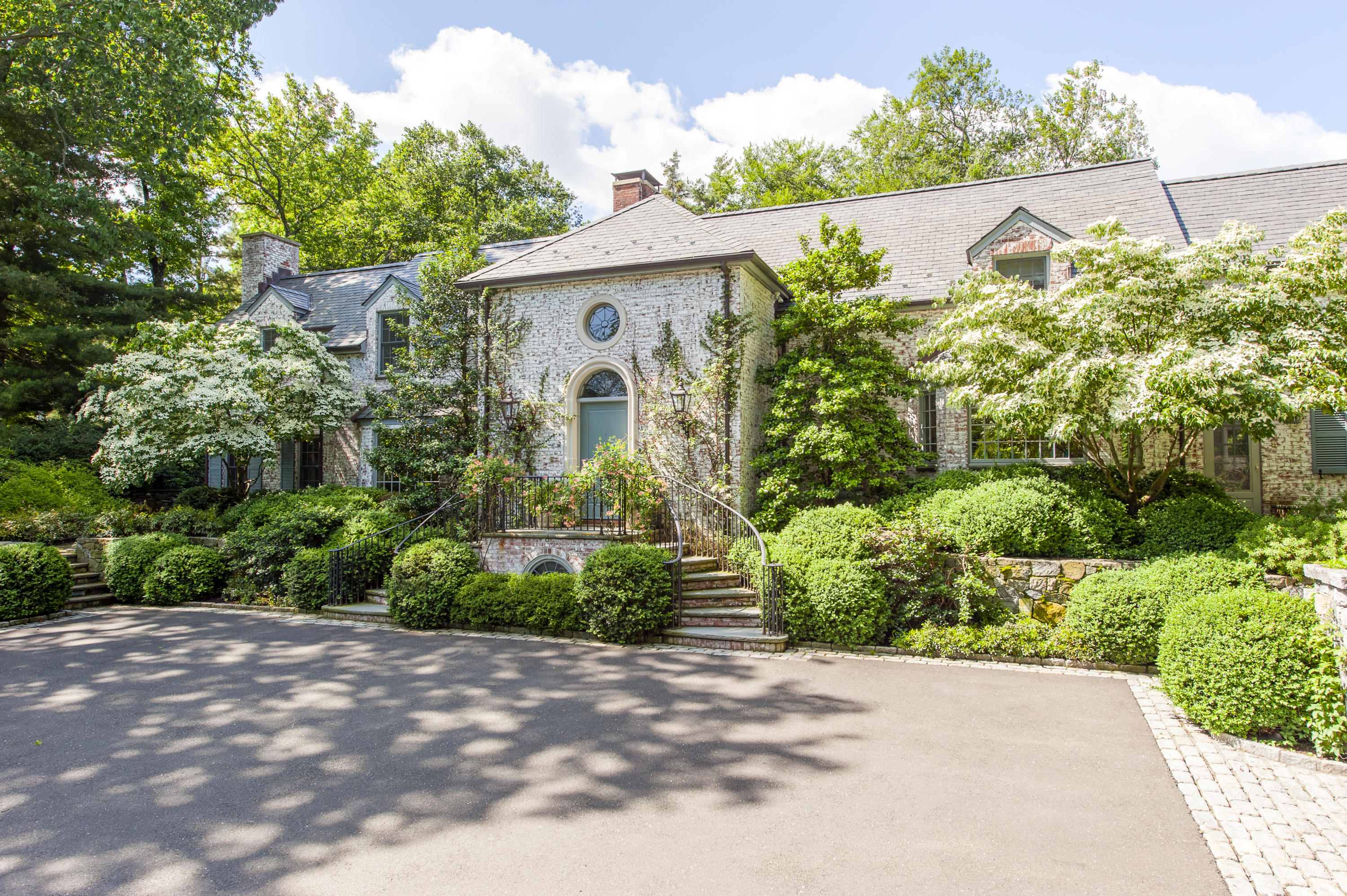 29 Sunswyck Road Darien, CT 06820 - Photo 4 of 59 a front view of a house with a yard and a garden
