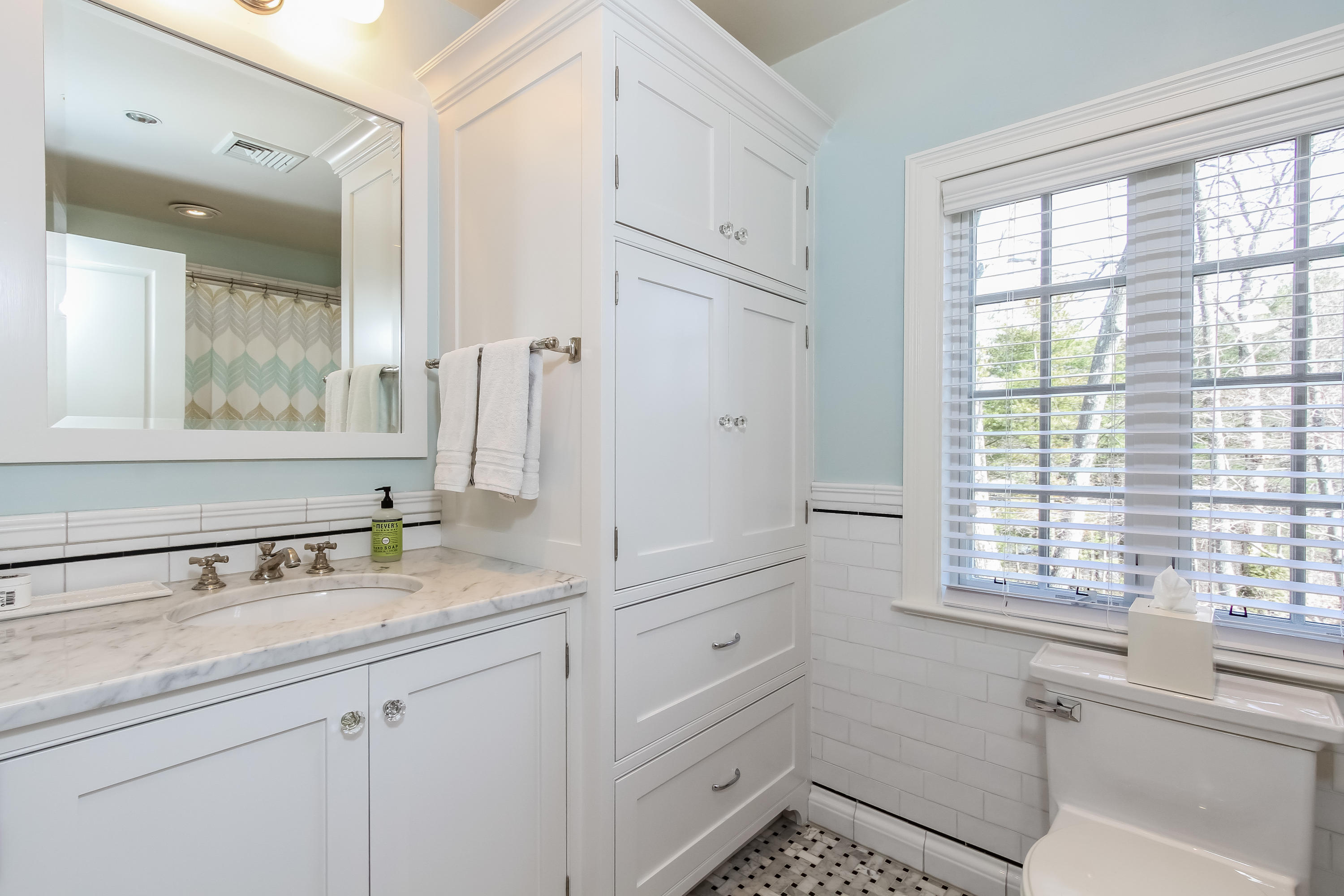 29 Sunswyck Road Darien, CT 06820 - Photo 41 of 59 a bathroom with a sink a vanity and a mirror