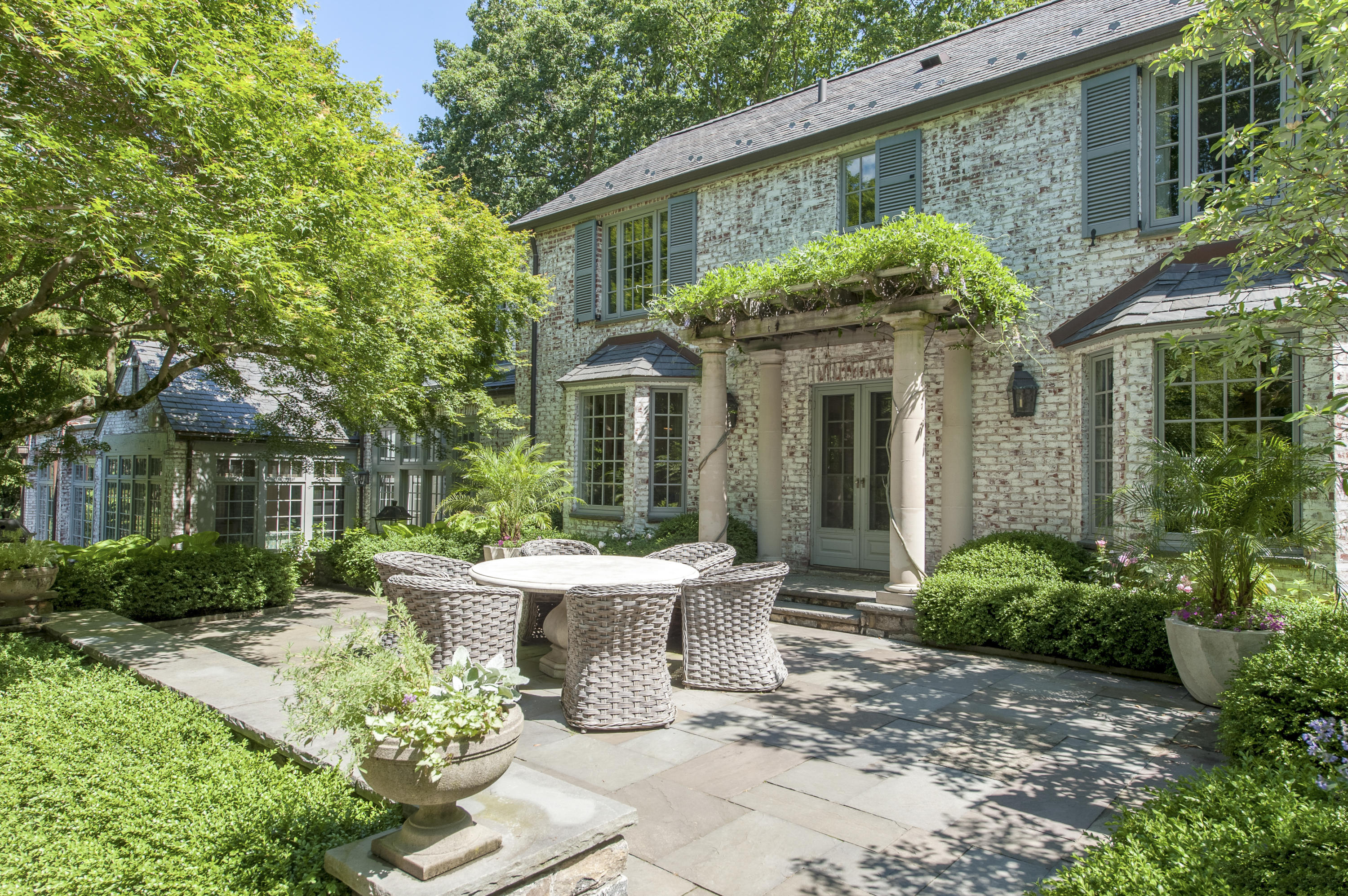 29 Sunswyck Road Darien, CT 06820 - Photo 44 of 59 a view of a patio with table and chairs and potted plants