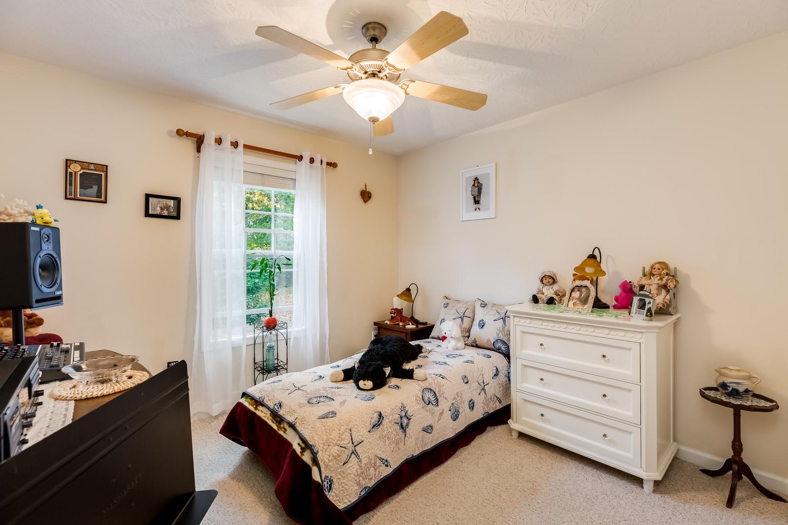 1529 Rapids Road Portland, TN 37148 - Photo 17 of 30 a bed room with a bed and a chandelier