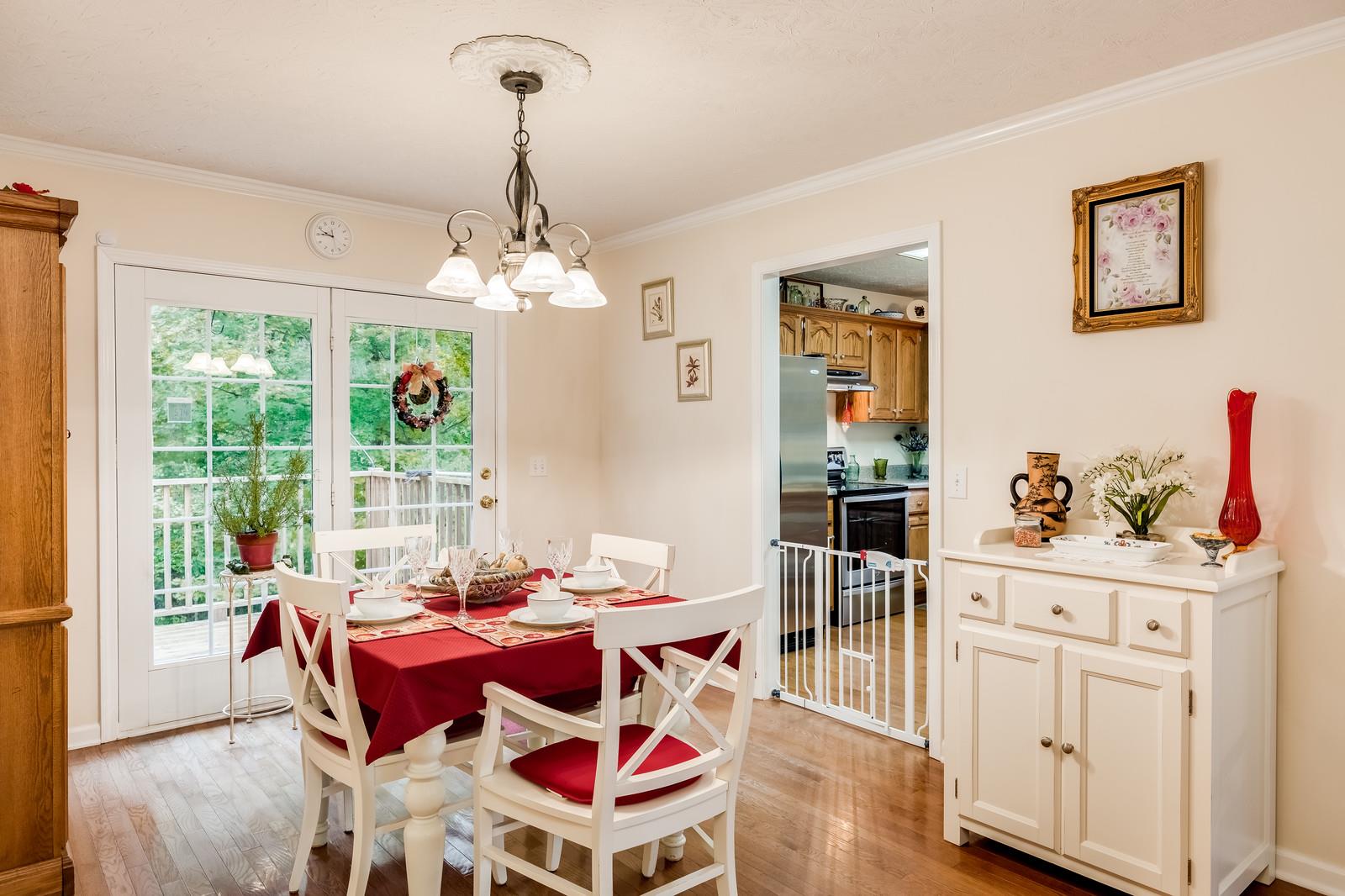 1529 Rapids Road Portland, TN 37148 - Photo 21 of 30 a dining room with furniture a chandelier and wooden floor