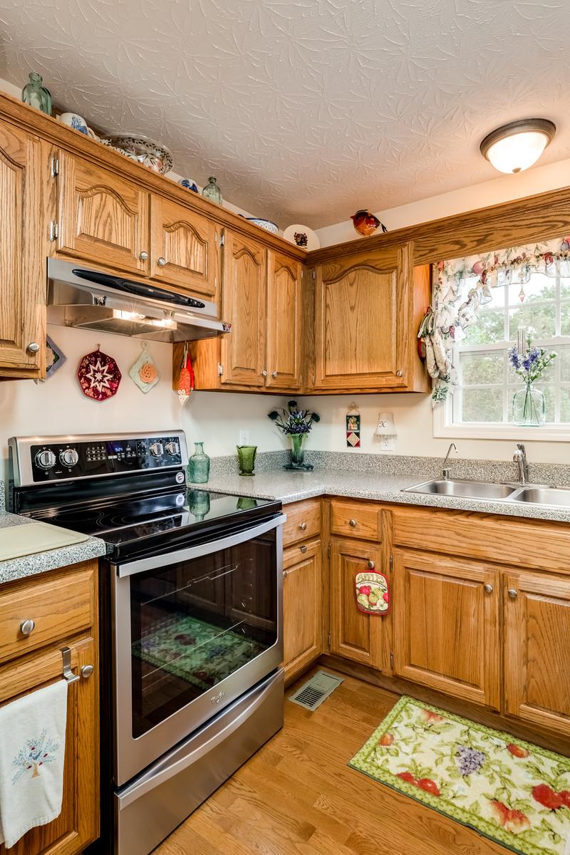 1529 Rapids Road Portland, TN 37148 - Photo 22 of 30 a kitchen with stainless steel appliances granite countertop a stove and cabinets