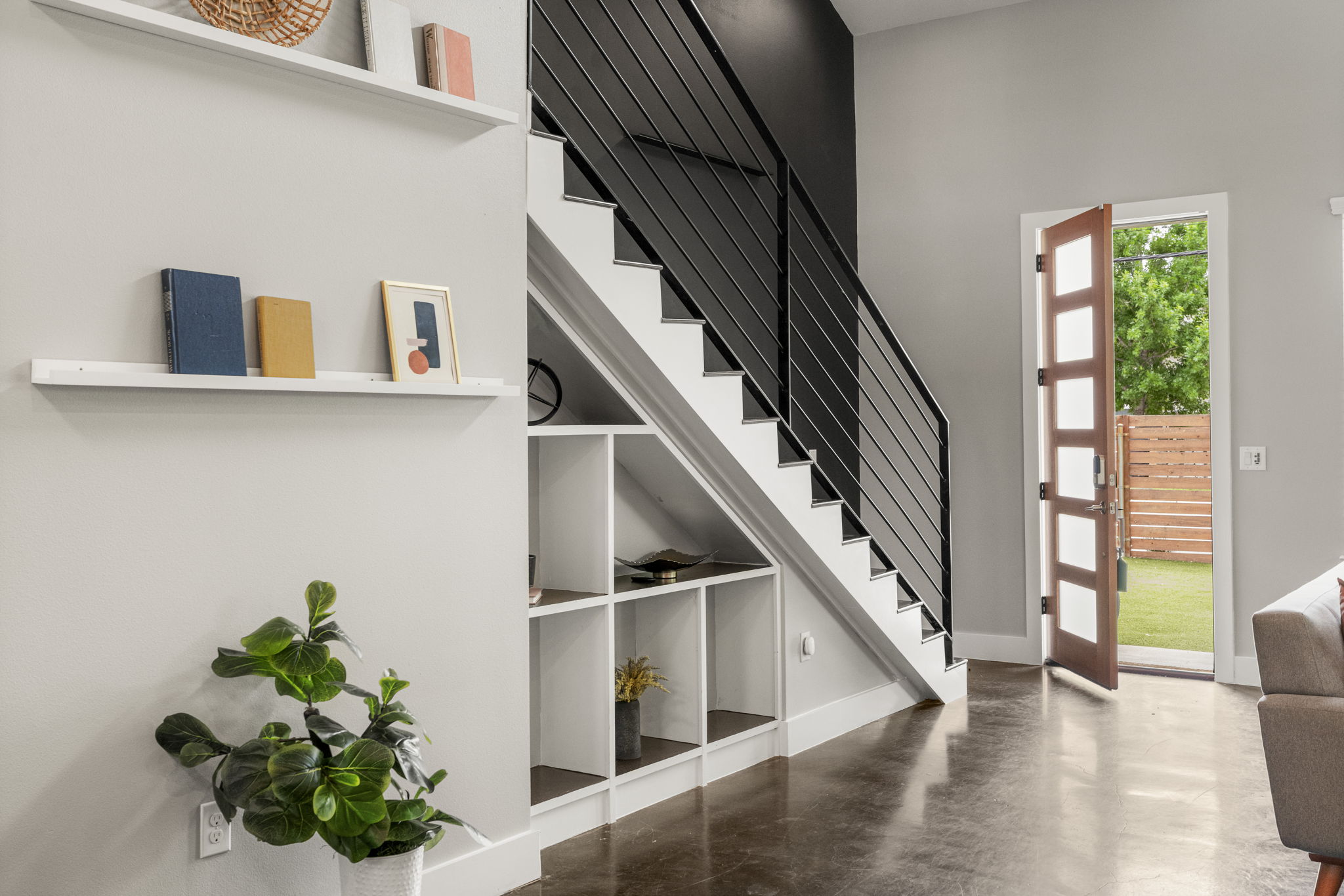 5204 Samuel Huston Avenue, Unit A Austin, TX 78721 - Photo 12 of 38 Modern staircase featuring a black metal railing and white risers