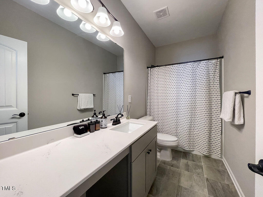 3604 Cross Timber Lane Raleigh, NC 27603 - Photo 12 of 15 a bathroom with a sink a toilet and shower