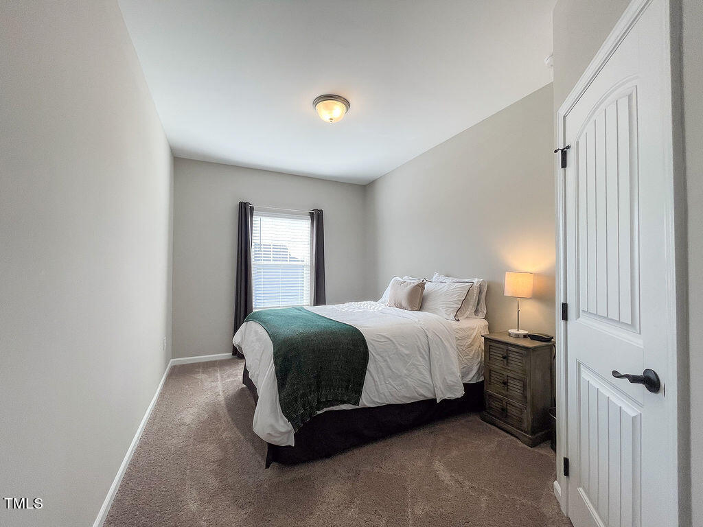 3604 Cross Timber Lane Raleigh, NC 27603 - Photo 14 of 15 a bedroom with a bed and a window