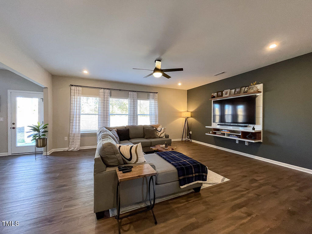 3604 Cross Timber Lane Raleigh, NC 27603 - Photo 6 of 15 a living room with furniture flat screen tv and a window