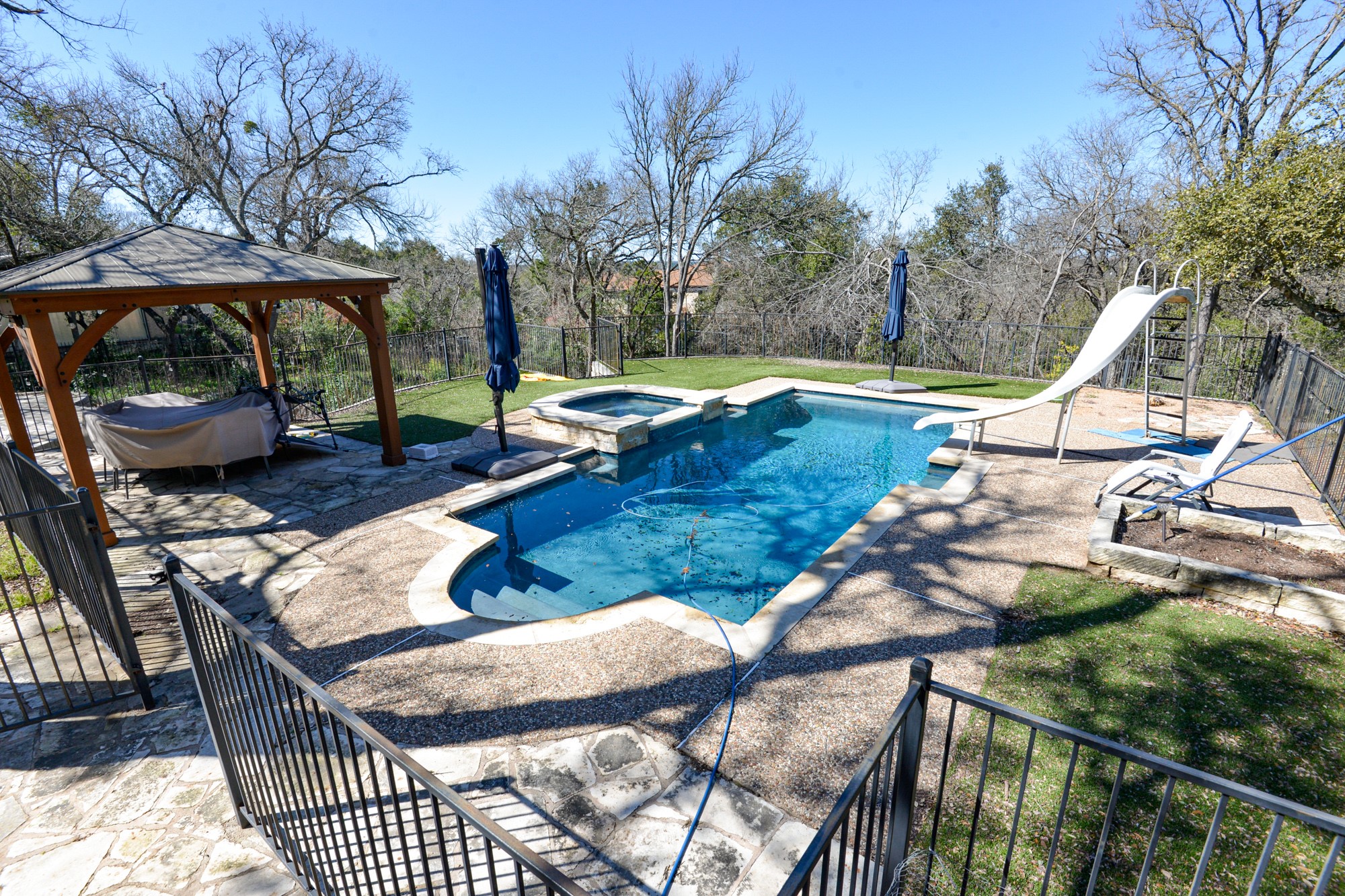 10710 D-K Ranch Road Austin, TX 78759 - Photo 1 of 34 An inviting backyard oasis awaits, complete with a refreshing pool, relaxing spa, and charming gazebo.