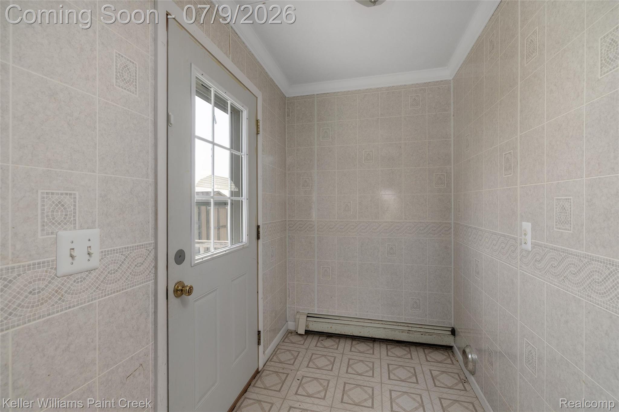 28780 School Section Road Richmond, MI 48062 - Photo 24 of 50 Entryway featuring a white door with window panes, patterned vinyl flooring, and tiled walls with decorative banding