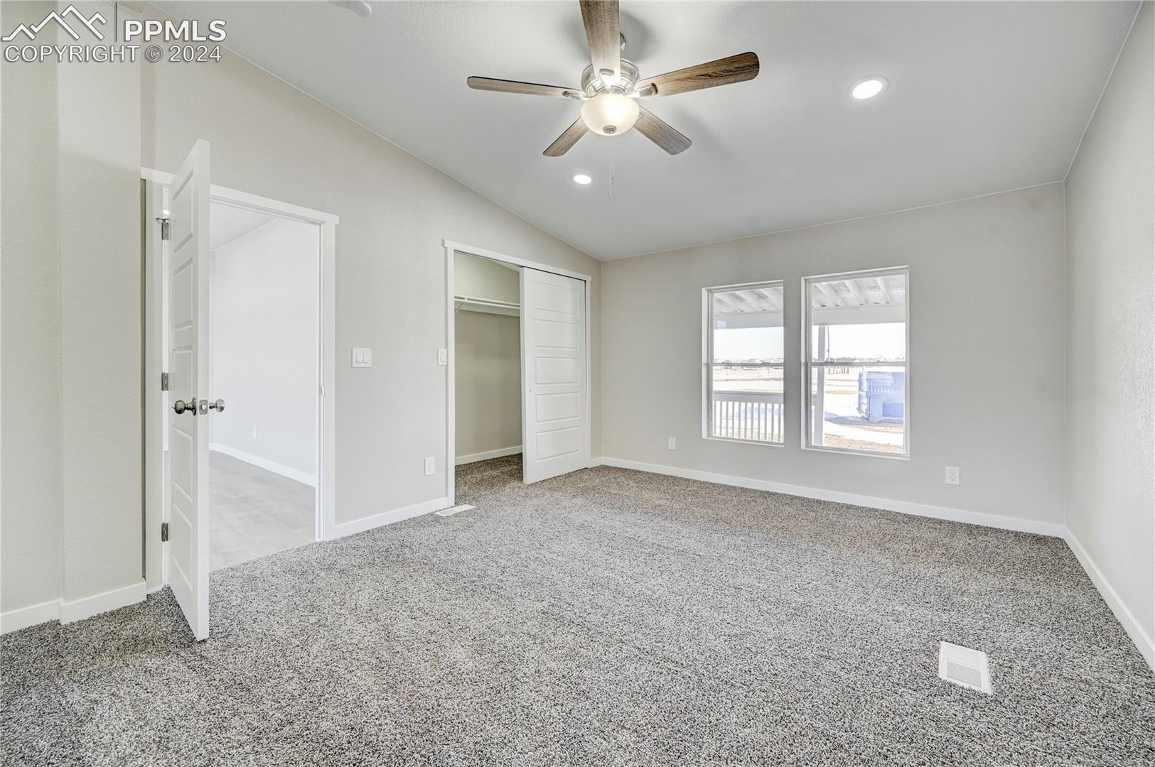 6605 Rio Road Peyton, CO 80831 - Photo 38 of 45 Unfurnished bedroom featuring light carpet, a closet, ceiling fan, and lofted ceiling