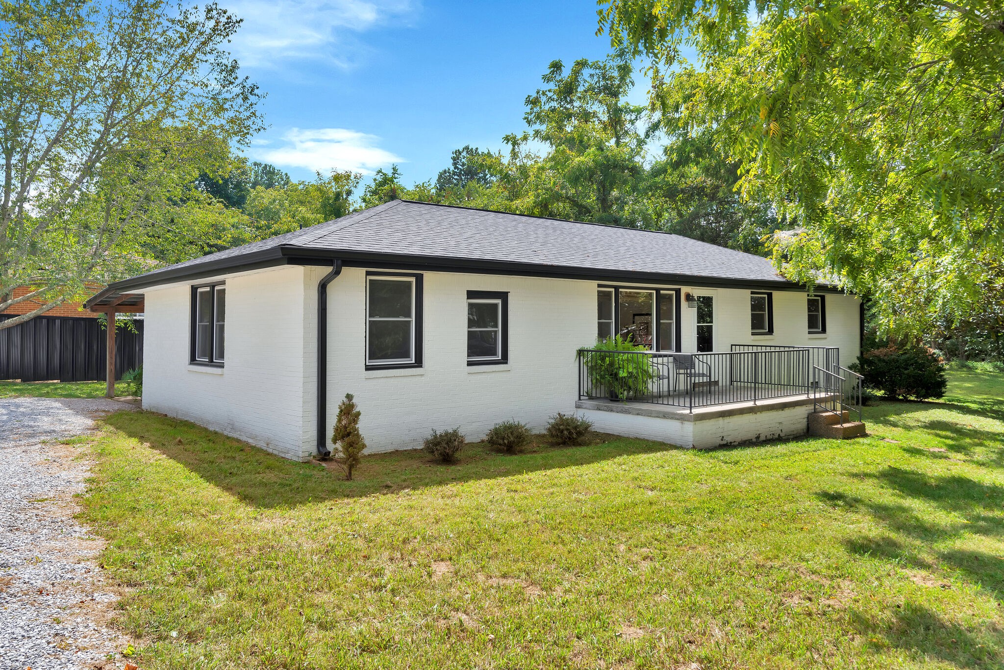a view of a house with backyard and sitting area