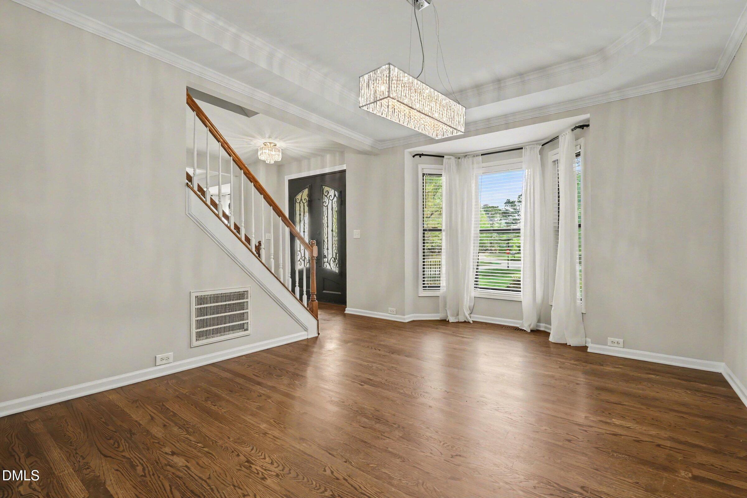 1001 Denfield Court Raleigh, NC 27615 - Photo 10 of 44 wooden floor in an empty room with a window