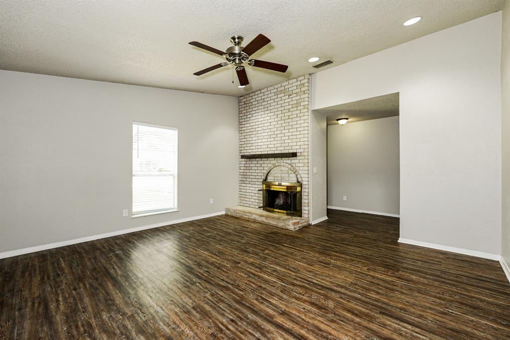 218 Long Shadow Lane Mesquite, TX 75149 - Photo 2 of 15 a view of empty room with wooden floor and ceiling fan