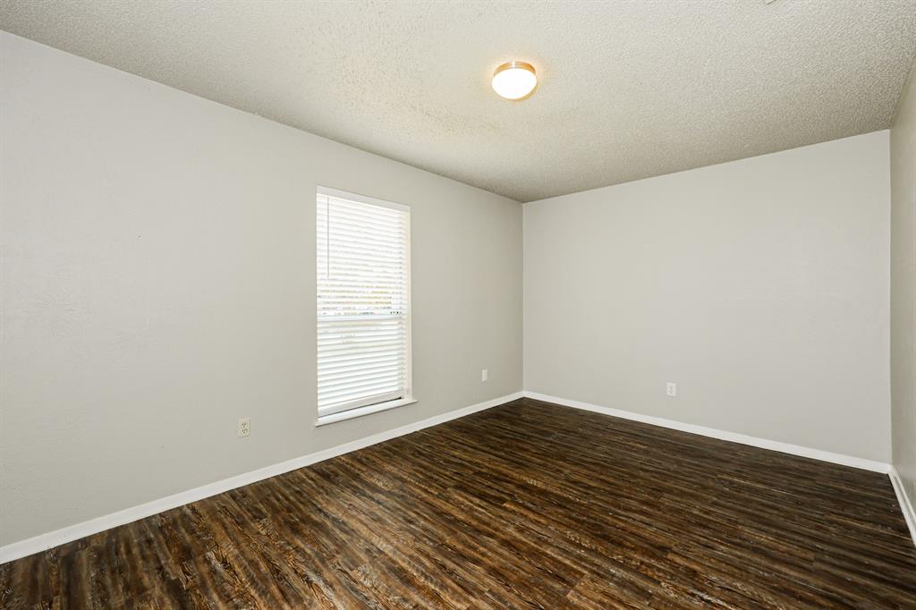 218 Long Shadow Lane Mesquite, TX 75149 - Photo 10 of 15 an empty room with wooden floor and windows