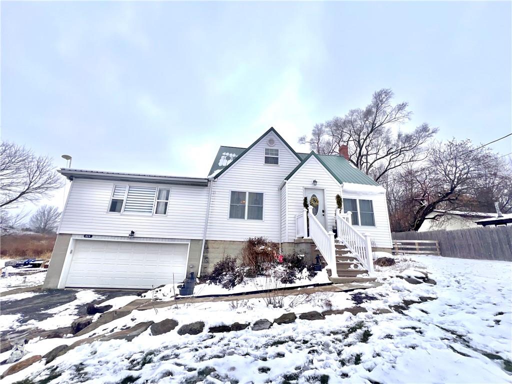 a front view of a house with a yard covered in snow