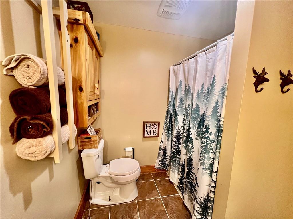 929 Mt Jackson Road New Castle, PA 16102 - Photo 9 of 21 a bathroom with a toilet and shower curtain